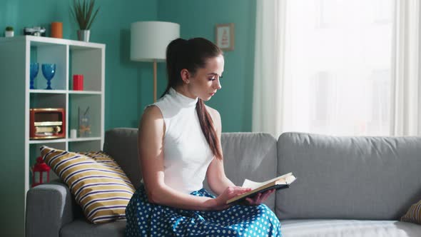 Young Woman Is Reading at Home