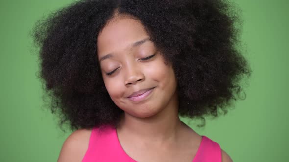 Young Cute African Girl with Afro Hair Relaxing with Eyes Closed