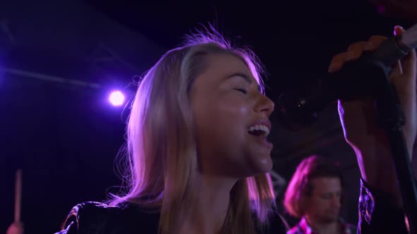 Female musician singing during a concert