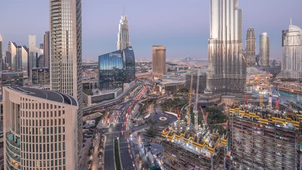 Panoramic Skyline View of Dubai Downtown After Sunset with Mall Fountains and Skyscrapers Aerial Day