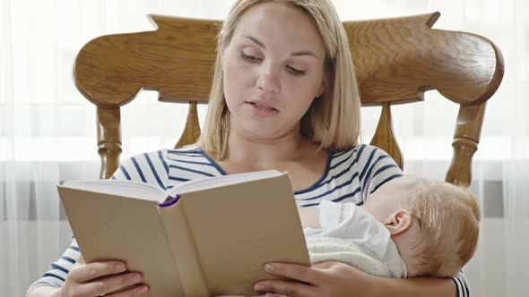 Blond Mother Reading Stories to Sleeping Baby Son