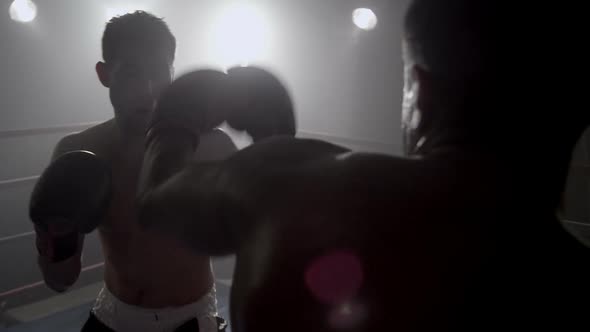 Boxer punching in boxing ring, POV