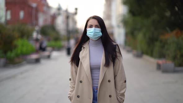 Portrait of a Mixed Race Woman in the City Streets During the Day, Wearing a Face Mask Against the