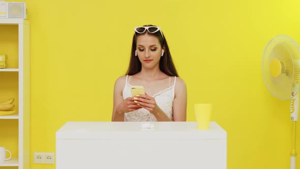 Woman In Wireless Headphones Is Texting Message