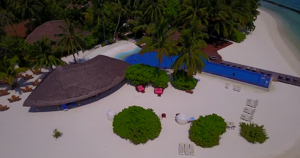 Beautiful birds eye clean view of a summer white paradise sand beach and aqua blue water background 