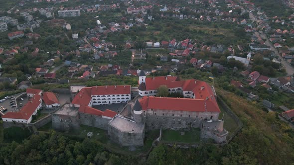 Aerial View of Medieval Castle on Mountain in Small European City at Cloudy Autumn Day