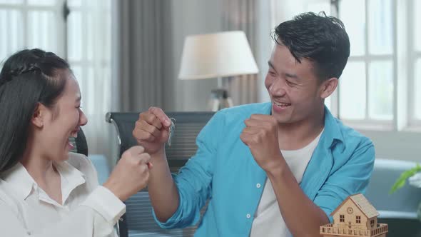 Close Up Of Asian Couple Receives The Keys From A Real Estate Agent Then Celebrates
