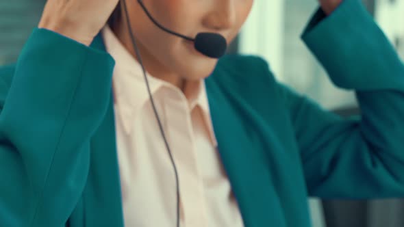 Businesswoman Wearing Headset Working Actively in Office