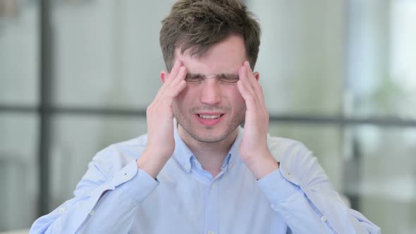 Portrait of Young Man Having Headache