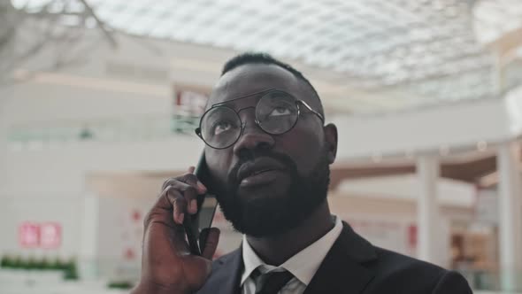 Close Up of Businessman Talking on Phone Indoors