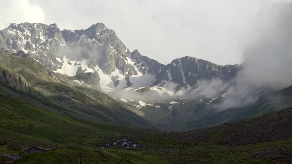 High Snowy Mountain Peaks on the Background of Glacial U Valley