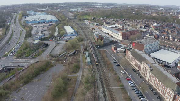 Aerial view, footage of a train leaving Stoke on Trent train station en route to Manchester in the M