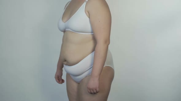 Corpulent Female in White Underwear Posing Before Camera, Overweight Person