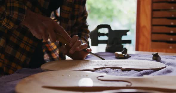 Female luthier at work in her workshop