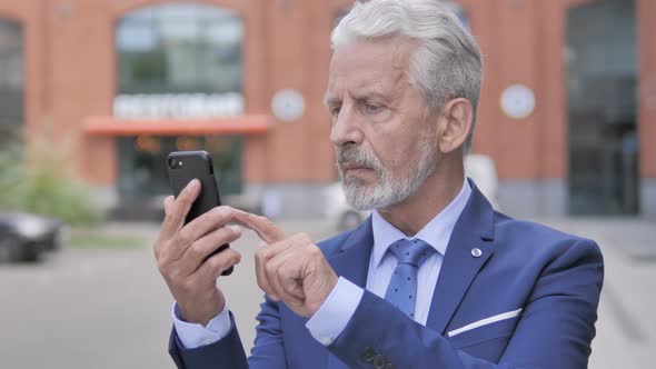 Old Businessman Using Smartphone