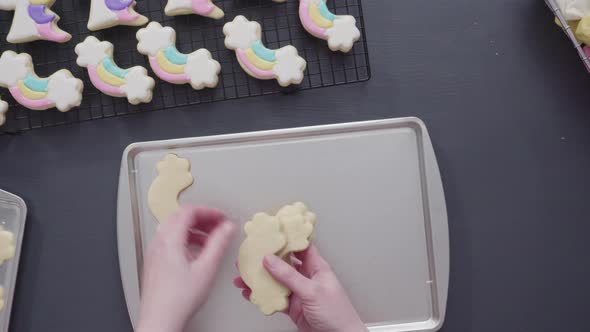 Time lapse. Step by step. Flat lay. Decorating unicorn sugar cookies with royal icing on baking sheet
