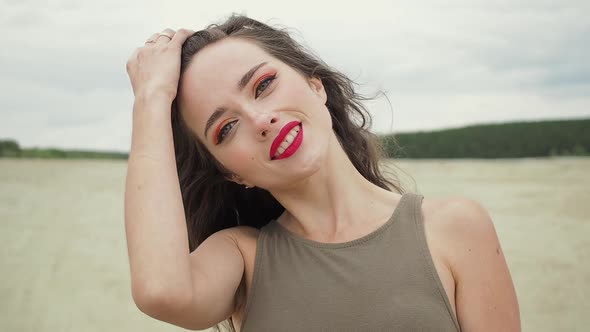 Pretty Woman Touching Hair on Beach