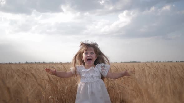 Child in Field, Emotional Little Girl in White Dress Runs with Arms Spread To Meeting To Across