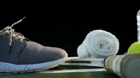 Water bottle, sports shoes and sports equipment in tennis court 4k