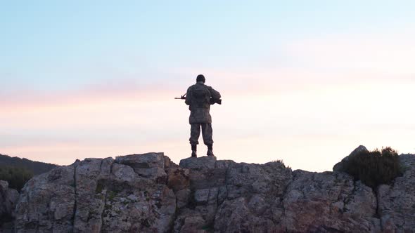 Soldier In The Morning Holds Guard With His Rifle