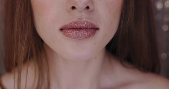 Closeup of Beautiful Young Female Model Lips with Nude Lipstick