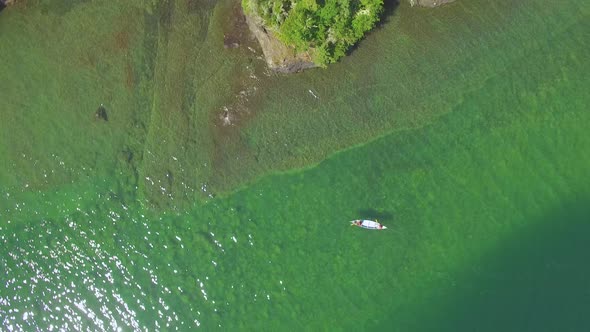 Overhead Aerial Of People Canoeing on Green Lake