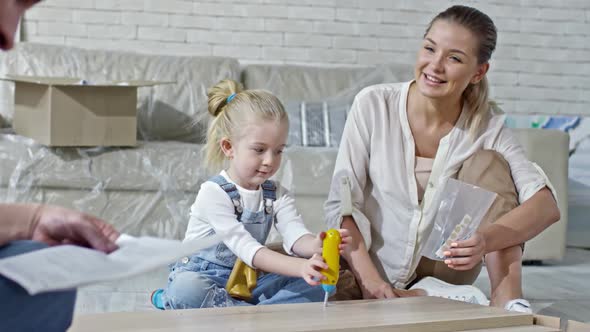 Girl Playing with Disassembled Furniture