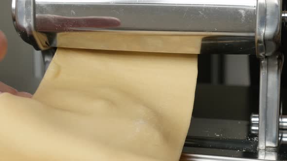 Close-up of manual pasta machine using at home 4K 2160p 30fps UltraHD footage - Making of Italian la