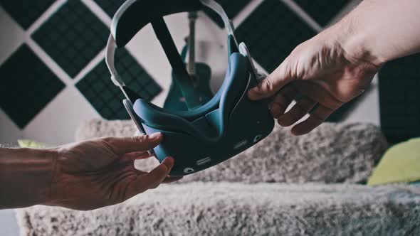 Point of View Young Man Putting on VR Helmet at Home Interior