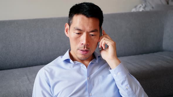 Man talking on mobile phone in living room