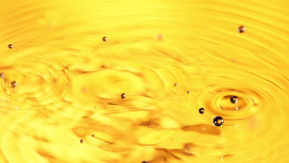 Super Slow Motion Detail Shot of Water Drop on Golden Luxury Background at 1000 Fps