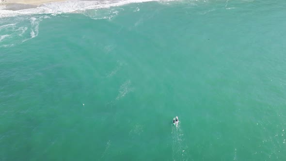 Kayakers Enjoying The Pristine Waters In Portreath Cornwall England- aerial wide shot