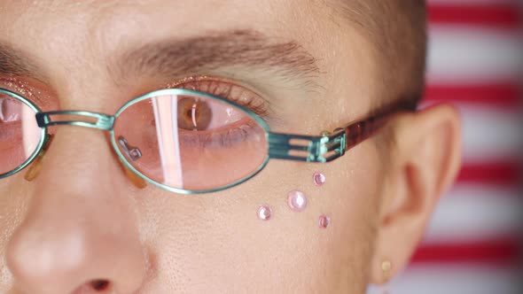 Close Up of Gay Man with Makeup Posing on American Flag