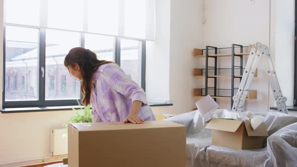 Woman with Adhesive Tape Packing Box at New Home