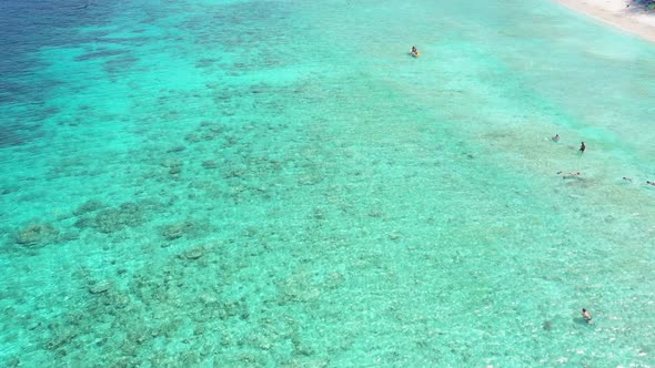 Motion Over Clear Ocean Shelf Zone with Resting Tourists