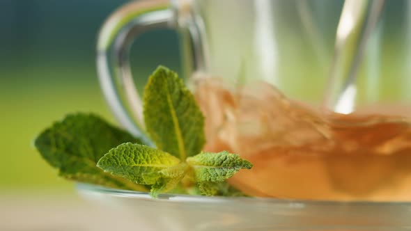 Pouring Hot Tea in Cup Closeup