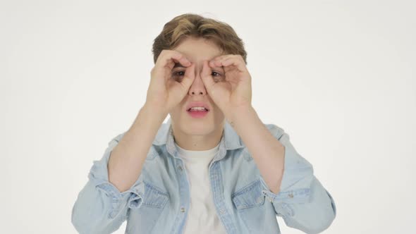 Young Man Searching with Handmade Binocular on White Background