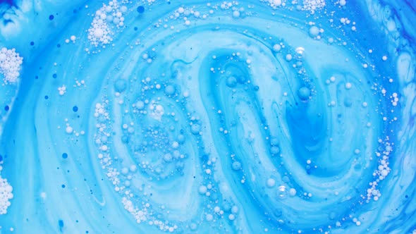 colored abstract background of mixing liquid paints on water surface, painted texture