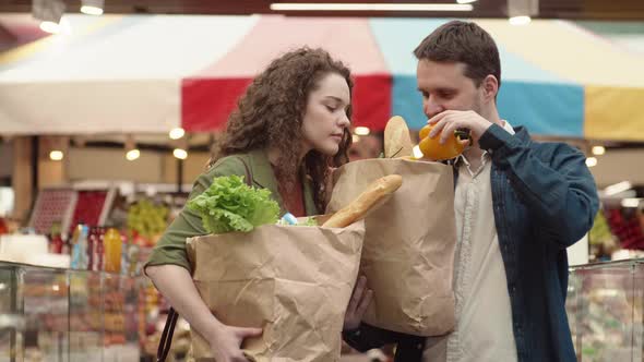 Man and Woman Shopping in Grocery Market