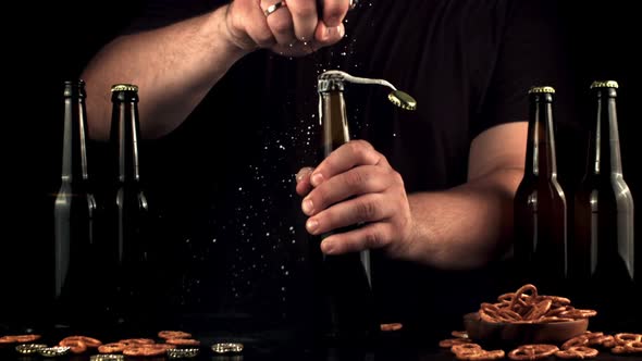 Super Slow Motion Men's Hands Open the Bottle with a Beer Opener