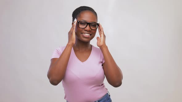 Happy African American Woman in Glasses Dancing