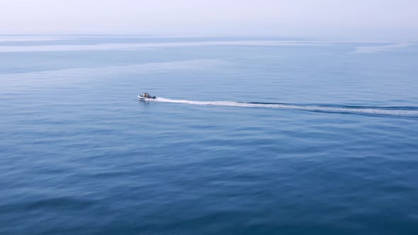 Boat fishing speeding into very calm mediterranean sea