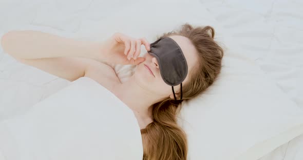 Young Woman Wakes Up Takes Off Her Sleep Mask and Goes on Gruddy