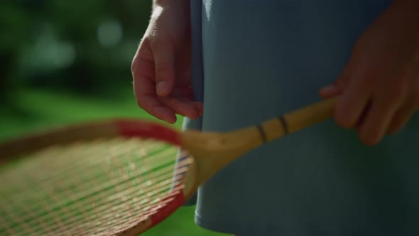 Closeup Child Hand Holding Badminton Racket Examining Net