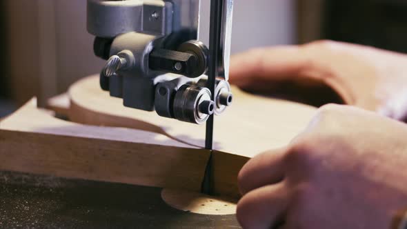 Closeup Hands of Male Carpenter Working on Milling Machine with Wood Detail