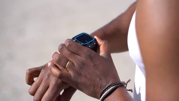 Cropped Shot of Man Checking Watch Outdoors