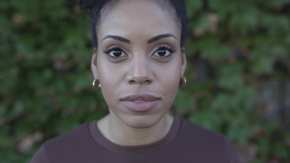 Happy Young Adult Woman Smiling at Camera Outdoors