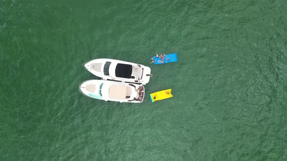 Two Yacht Boats with People Enjoying Summer Vacation in Miami, Florida - Aerial View Directly Above
