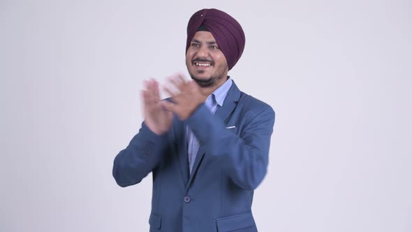 Happy Bearded Indian Sikh Businessman Clapping Hands