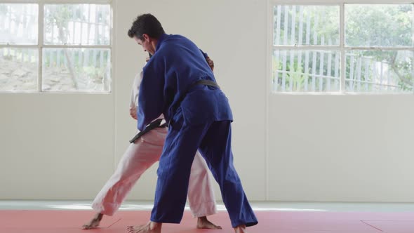 Judokas training by doing a randori on the judo mat